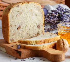 Freshly baked homemade wholegrain bread with walnuts, honey and lavender. Delicious gourmet pastries with dry flowers. Selective focus