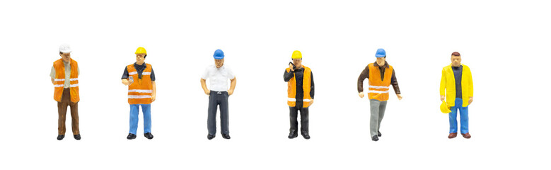 Miniature figurine character as worker wearing safety vest and posing in posture isolated on white background.