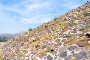 Fragment of the sun pyramid in Teotihuacan. Structure of ancient stones. Travel photo, background, wallpaper, texture. Mexico.