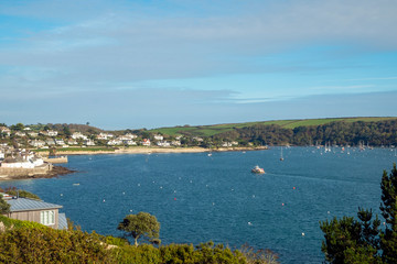 Fototapeta na wymiar Looking back across blue sea towards St Mawes town, Cornwall, England, UK