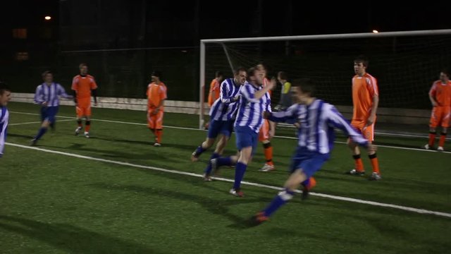 Scoring a Goal during a Football / Soccer Match. The player heads the ball past the goalkeeper from a corner. Stock Video Clip Footage