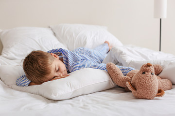 Cute little boy sleeping in bed