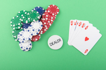 cards and poker chips - green background