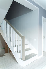 Wooden stylish staircase in the house. Interior.