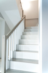 Wooden stylish staircase in the house. Interior.