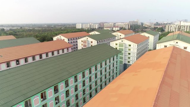 Low level aerial drone flight over rooftop buildings of Pathum Thani