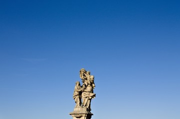 Fototapeta na wymiar Isolated statue with pigeons in the Charles Bridge (Prague, Czech Republic, Europe)