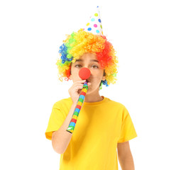 Little boy in funny disguise and with party whistle on white background. April fools' day celebration