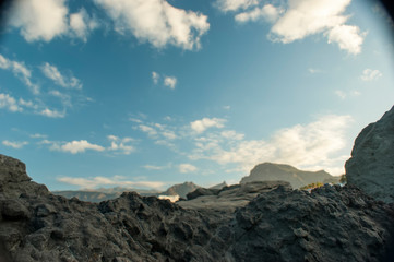 A huge rock of lava against the sky. Dawn in the southern sky.