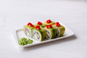 Vegetarian sushi avocado rolls with Philadelphia cream cheese, sesame seeds, unagi sauce. Sushi menu. Japanese food.
