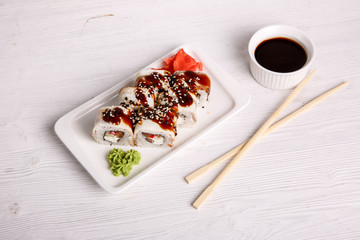 eel rolls on a light wooden background