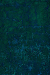 fantastic turquoise painted wall with cracks and peeling paint flakes