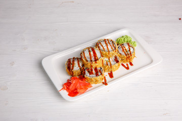 Deep-fried Japanese roll with tiriaki sauce. Traditional Japanese cuisine, menu on a white background