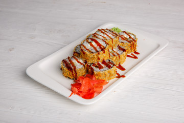 Deep-fried Japanese roll with tiriaki sauce. Traditional Japanese cuisine, menu on a white background