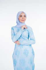 Beautiful Muslim female model wearing pastel blue modern kurung with hijab, a urban lifestyle apparel for Muslim women isolated on white background. Beauty and hijab fashion concept. Half length