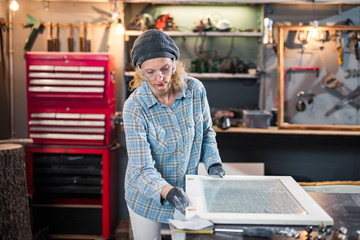 Carpenter working on the old wood in a retro vintage workshop.