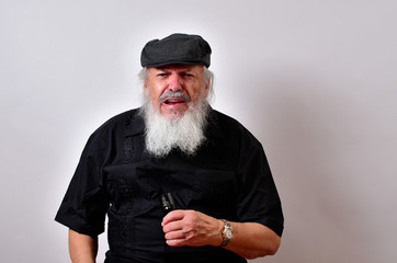 Kranky old man holding a flashlight.Elderly gentleman holding a flashlight.Senior man scowling