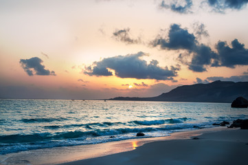 Naklejka na ściany i meble Beautiful sunrise on a deserted wild coast on an island in the Indian Ocean.