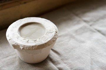 Mold for casting clay products with a mixture inside. Shaped method for making clay dishes. Handwork. Pottery making