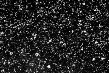 Black and white abstract background, texture of bright white gems, diamonds and crystals