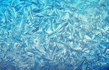 natural textured background with a beautiful frosty pattern on the glass on a winter morning