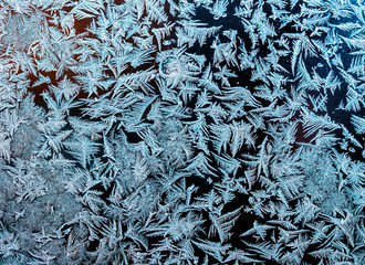 natural textured background with a beautiful frosty pattern on the glass on a winter morning