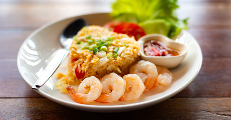 Close up spicy shrimp with Fried rice on wooden table , Home made food Thai style.Photo select focus.