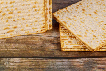 Jewish matzah bread on wooden background. Passover holiday concept