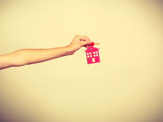 Person holding keys with pendant in house shape