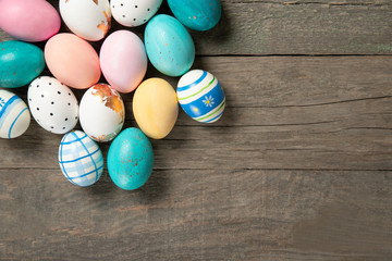 Easter eggs on old wooden background, place for text, top view