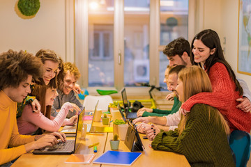 Young teamwork using computer in the apartment. Millennial people working together at new project. Young people looking cute videos. Technology, influencer, marketing and job concept - Image