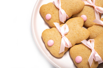 Easter cookies on a plate on a white background, place for text, easter bunny, top view, isolation,