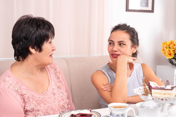 Mom and adult daughter spending time together at home.