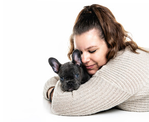 Beautiful woman with french bulldog lay over white