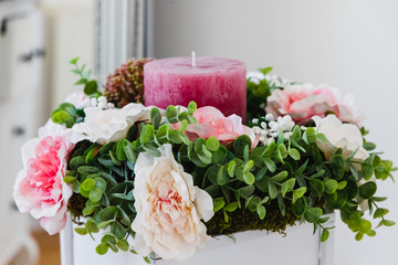 Wedding bouquet with a large pink cnadle in the middel