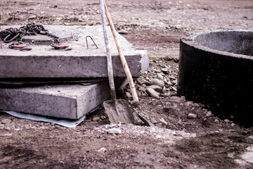 Сoncrete slabs and shovels at a construction site. Road working. 