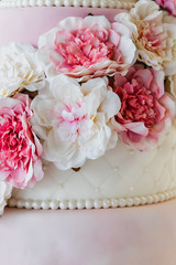 Wedding cake with pink flowers as decoration