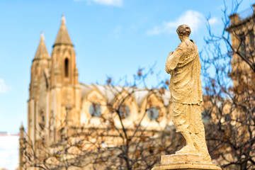 Fototapeta na wymiar View of Balluta square in Sliema, Malta. Back of stone figure looking on Parish Church of Our Lady of Mount Carmel, or simply known as the Carmelite Church or Balluta Parish Church. Travel, tourism
