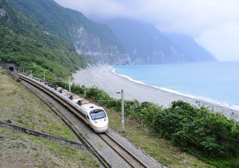 An electric passenger train near the pacific ocean