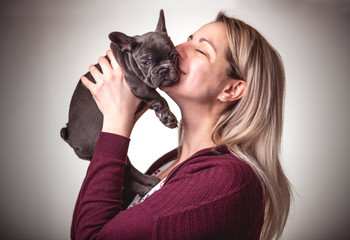 Beautiful woman with french bulldog on studio