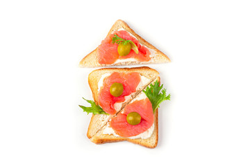 Appetizer, open sandwich with salmon and soft cheese on white background. Traditional Italian or Scandinavian cuisine. Concept of proper nutrition and healthy eating. Flat lay, copy space for text