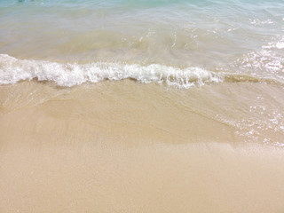 White sand and water on the seashore as a background