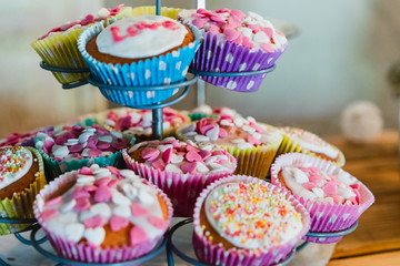 Cupcakes with different decorations on a cupcake tree