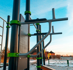 Fitness exercise equipment in the park at sunset