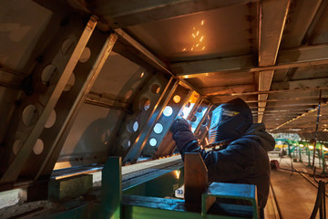 Obraz na płótnie Canvas welding work, welder,man in a welding mask