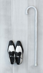 white shoes and cane for walking on a white wooden table