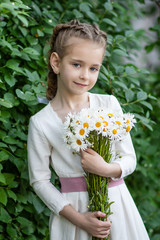  a girl with a bouquet of daisies walks in the park, a girl with flowers