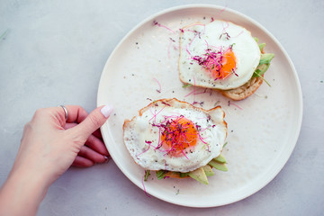 Healthy food concept. Tasty sandwich with avocado and fried eggs