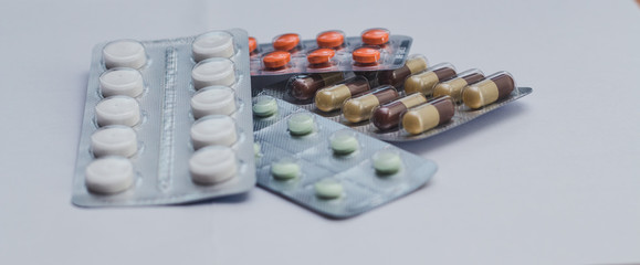 Close up pills in package on white background