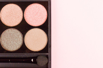 set of pastel eyeshadows isolated on rose background